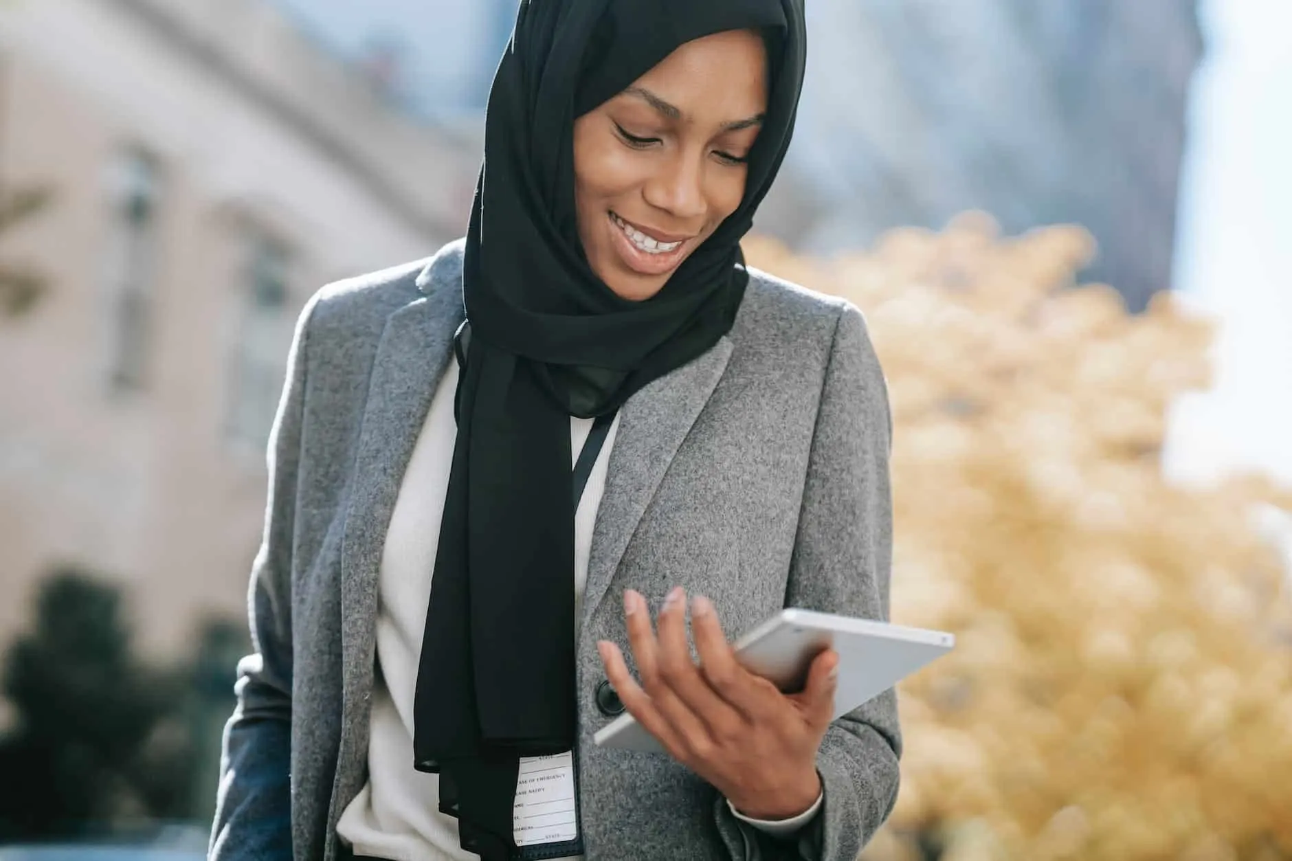 black woman in hijab browsing tablet